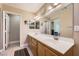 Bright bathroom features double sinks, a large mirror, and neutral tile flooring at 1116 Avellino Ln, Las Vegas, NV 89144