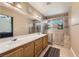 Well-lit bathroom featuring double sinks, a walk-in shower, and modern fixtures at 1116 Avellino Ln, Las Vegas, NV 89144
