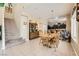 Open-concept dining area adjacent to the kitchen with wood table and staircase at 1116 Avellino Ln, Las Vegas, NV 89144