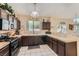 Kitchen featuring dark cabinetry, modern appliances, and an open layout perfect for entertaining at 1116 Avellino Ln, Las Vegas, NV 89144
