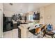 Kitchen featuring dark cabinetry, tiled countertops, breakfast bar, and modern appliances at 1116 Avellino Ln, Las Vegas, NV 89144