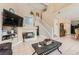 Open-concept living room featuring a fireplace, staircase, and dining area at 1116 Avellino Ln, Las Vegas, NV 89144