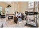 Open-concept living area with high ceilings, fireplace, office space, and tile flooring throughout at 1116 Avellino Ln, Las Vegas, NV 89144
