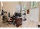 Bright, open living room with high ceilings, large windows, tile floors, and a dedicated office space at 1116 Avellino Ln, Las Vegas, NV 89144