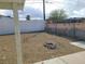 An empty backyard is covered in gravel, featuring a fire pit and perimeter walls at 129 Maple St, Henderson, NV 89015