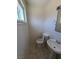A clean half bathroom features tiled floors, a pedestal sink, and essential fixtures at 129 Maple St, Henderson, NV 89015