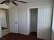 This bedroom features wood floors, a closet and access to another room through a door at 129 Maple St, Henderson, NV 89015