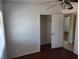 This bedroom features wood floors, a ceiling fan, a closet and access to another room at 129 Maple St, Henderson, NV 89015