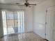 Cozy dining area featuring tile flooring, backyard access, and a ceiling fan for added comfort at 129 Maple St, Henderson, NV 89015
