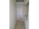 Hallway with access to the laundry and bedroom features tile flooring and neutral walls at 129 Maple St, Henderson, NV 89015