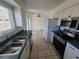 Bright kitchen with stainless steel appliances, including a microwave, and a double basin sink overlooking the house at 129 Maple St, Henderson, NV 89015