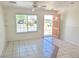 Inviting living room features tile flooring, an open front door, and plenty of natural light from the window at 129 Maple St, Henderson, NV 89015