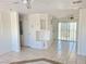 Bright living area includes tile flooring, backyard access, and is adjacent to the kitchen appliances at 129 Maple St, Henderson, NV 89015
