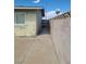 A narrow side yard features concrete and a block wall at 129 Maple St, Henderson, NV 89015