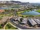 Gorgeous aerial view of a lakeside community with a golf course and elegant homes nestled in a scenic landscape at 15 Reflection Bay Dr, Henderson, NV 89011