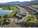 Aerial shot of a Primary-planned community on a golf course, featuring a lake and well-maintained streets at 15 Reflection Bay Dr, Henderson, NV 89011