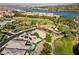 Overhead view of high end homes in a golf community near a lake, surrounded by lush landscaping and mature trees at 15 Reflection Bay Dr, Henderson, NV 89011