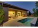 Backyard featuring a pool, travertine patio, and a covered patio at 15 Reflection Bay Dr, Henderson, NV 89011