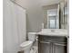 This bathroom features a toilet, sink, and a shower curtain at 15 Reflection Bay Dr, Henderson, NV 89011