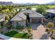 Exterior of home with stone facade, desert landscaping and mountain view at 15 Reflection Bay Dr, Henderson, NV 89011