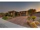 Charming single-story home featuring stone accents, desert landscaping, and a brick driveway at 15 Reflection Bay Dr, Henderson, NV 89011