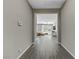 Hallway with wood flooring leading to living area, enhanced by natural light at 15 Reflection Bay Dr, Henderson, NV 89011