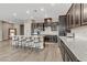 Open kitchen featuring an island with barstool seating and modern appliances at 15 Reflection Bay Dr, Henderson, NV 89011