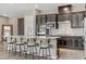 Kitchen island with stylish seating, stainless appliances, and pendant lighting at 15 Reflection Bay Dr, Henderson, NV 89011