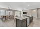 Kitchen featuring an open floor plan, an island with bar seating, and a dining area at 15 Reflection Bay Dr, Henderson, NV 89011