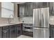 Modern kitchen featuring stainless steel appliances, dark wood cabinets, and granite countertops at 15 Reflection Bay Dr, Henderson, NV 89011