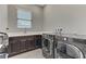 This laundry room features a washer, dryer, sink, and white countertops at 15 Reflection Bay Dr, Henderson, NV 89011