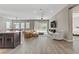 Bright open-concept living space featuring wood floors, neutral tones, and lots of natural light at 15 Reflection Bay Dr, Henderson, NV 89011