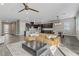 Open-concept living space with modern furnishings, kitchen, and dining area at 15 Reflection Bay Dr, Henderson, NV 89011