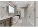 This main bathroom offers double sinks, a luxurious soaking tub, and a glass-enclosed walk-in shower at 15 Reflection Bay Dr, Henderson, NV 89011