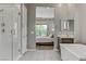 This main bathroom features a glass walk-in shower, a soaking tub, and an adjoined room at 15 Reflection Bay Dr, Henderson, NV 89011
