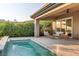 Backyard patio features an in-ground splash pool with waterfall feature and stylish outdoor furniture at 15 Reflection Bay Dr, Henderson, NV 89011