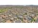 Aerial view featuring numerous houses and desert landscaping with a golf course in the distance at 184 Bird Cove Ave, Henderson, NV 89011