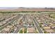Expansive aerial view showcases a neighborhood with desert landscape and modern houses, some equipped with solar panels at 184 Bird Cove Ave, Henderson, NV 89011