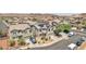 Expansive aerial view of a vibrant community showcasing modern homes with solar panels, desert landscaping, and scenic mountain backdrop at 184 Bird Cove Ave, Henderson, NV 89011