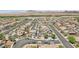 Expansive aerial view showcases a neighborhood with desert landscape and modern houses, some equipped with solar panels at 184 Bird Cove Ave, Henderson, NV 89011