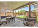 Relaxing backyard with covered patio, outdoor seating, and lush artificial turf at 184 Bird Cove Ave, Henderson, NV 89011