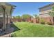 Lush backyard with artificial grass and mature landscaping, perfect for relaxation and outdoor activities at 184 Bird Cove Ave, Henderson, NV 89011