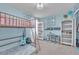 Bright bedroom featuring a loft bed, decorative bookshelf, and a cozy desk setup at 184 Bird Cove Ave, Henderson, NV 89011