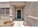 Welcoming front door with decorative metalwork, leading to a covered porch and entryway at 184 Bird Cove Ave, Henderson, NV 89011