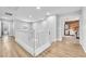 Bright upstairs hallway with hardwood floors leading to bedrooms, showcasing the home's layout at 184 Bird Cove Ave, Henderson, NV 89011