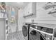 Well-organized laundry room with modern washer and dryer, plus custom cabinets at 184 Bird Cove Ave, Henderson, NV 89011