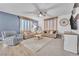 Inviting living room with plush gray carpet, comfortable seating, and a ceiling fan for added comfort at 184 Bird Cove Ave, Henderson, NV 89011