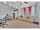 Office with large comfortable couch, window, and modern office chair. Neutral colors at 184 Bird Cove Ave, Henderson, NV 89011