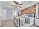 Warm and inviting main bedroom with a wood accent wall, ceiling fan, and a comfortable iron bed frame at 184 Bird Cove Ave, Henderson, NV 89011