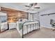 Cozy bedroom features a stylish wood accent wall, a comfortable bed, and ample natural light at 184 Bird Cove Ave, Henderson, NV 89011